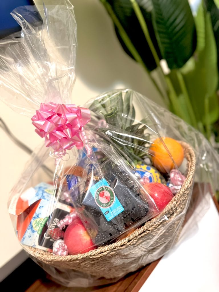 A fresh fruit basket arranged and wrapped as a gift